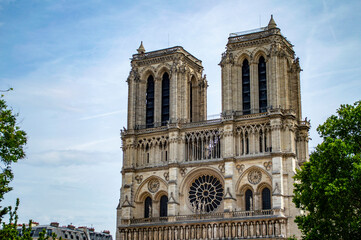 Naklejka na ściany i meble Paris, France - July 18, 2019: The facade of the belfry of Notre Dame cathedral in Paris, France