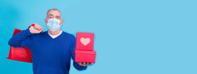 attractive man with protective mask on his face for coronavirus or covid-19 and present concept...