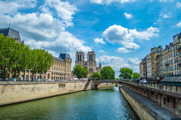 Fototapeta na wymiar Paris, France - July 19, 2019: A scenic view of Paris with river Seine and Notre Dame cathedral