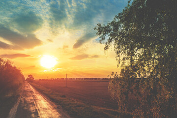 Rural landscape in the evening during sunset with beautiful cloudy sky