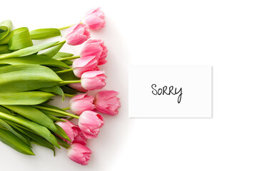 word SORRY and bouquet of tulips