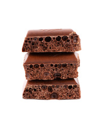 Porous chocolate pieces isolated on white background. Black aerated chocolate.
