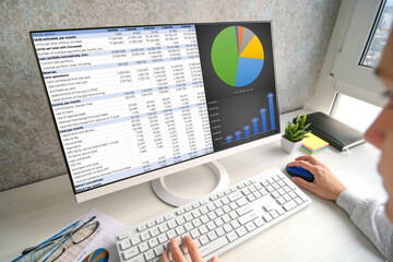 Girl works with data. Soft focus and blur on first plan.