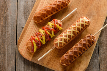 Waffle corn dogs with mustard and ketchup
