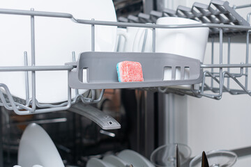 A tablet of a detergent for washing dishes in dishwashing machine