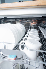 Open dishwasher with dishes inside