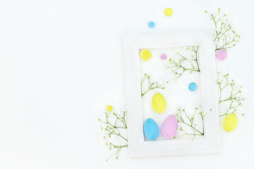 Easter spring composition with color eggs, flowres and frame 