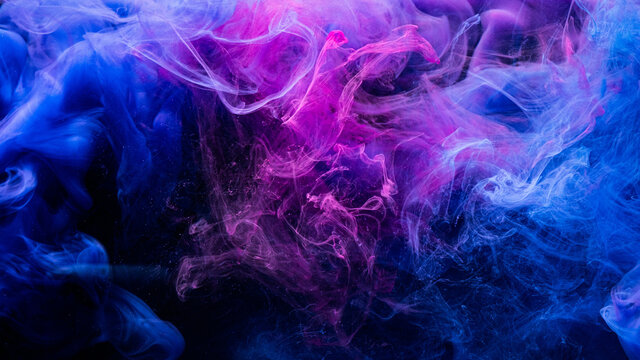 Color explosion. Fluorescent background. Paint in water. Vibrant smoke cloud texture. Glowing neon blue magenta pink steam splash on dark.