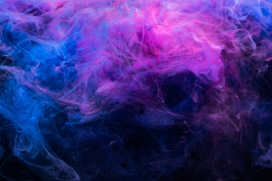 Color vapor. Abstract background. Ink in water splash design. Ultraviolet steam texture. Glowing bright blue magenta pink gas cloud on dark.