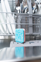 A tablet of a detergent for washing dishes in dishwashing machine
