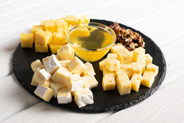 Cheese plate and honey with different kind of cheese