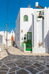 Fototapeta premium Traditional alley with whitewashed houses during winter time in lefkes Paros island
