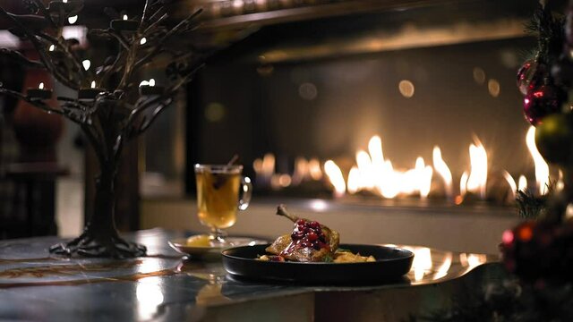Duck with mulled wine on the background of the fireplace