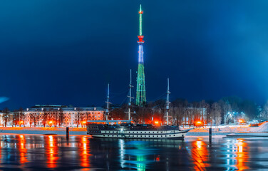 Fototapeta premium Sailboat on the Volkhov River. Veliky Novgorod TV Tower, night view. Winter city.