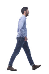 young man in jeans striding confidently forward.