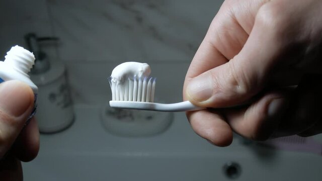Man takes dental brush. Toothbrush with toothpaste close up. Cleaning teeth concept. Hygiene concept.