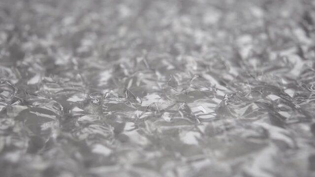 Plastic bubble packing wrinkled material. Macro. Dolly shot