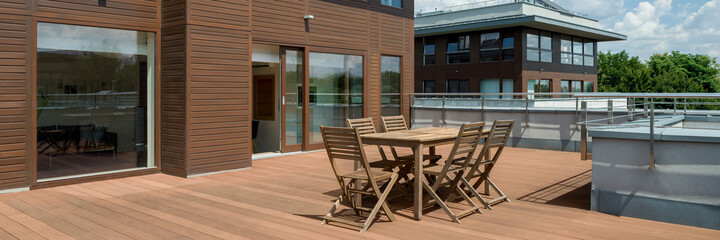 Fototapeta na wymiar Wooden furniture on terrace, panorama