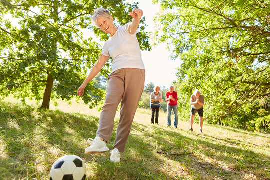 Active and vital senior woman playing soccer