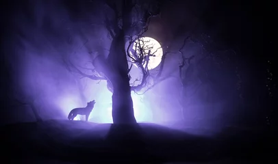 Deurstickers Silhouette of howling wolf against dead forest skyline and full moon. Creative artwork decoration. © zef art