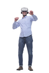 in full growth. smiling young man wearing virtual reality glasses.