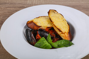 Mussels in the bowl with bread