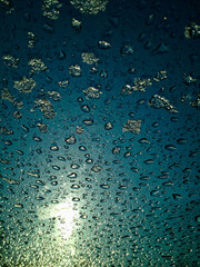 frosty natural pattern on winter window, drops and sun 