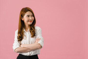 Portrait of young Asia lady with positive expression, arms crossed, smile broadly, dressed in casual clothing and looking at space over pink background. Happy adorable glad woman rejoices success.