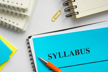 Syllabus educational plan and papers on the desk.