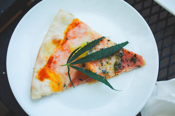 Pizza a mixture ofcannabis leaves, developed for health lovers in a new, licensed and legal form. Guaranteed safety, help relieve anxiety, reduce sadness. Concept Cannabis for health.