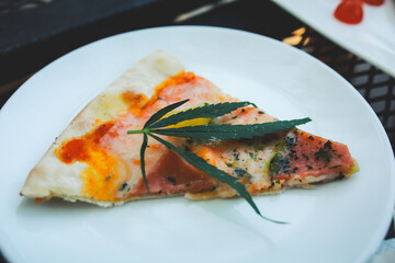 Pizza a mixture ofcannabis leaves, developed for health lovers in a new, licensed and legal form. Guaranteed safety, help relieve anxiety, reduce sadness. Concept Cannabis for health.