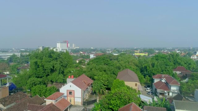 Aerial footage aerial landscape view of Yogyakarta city, Indonesia from drone flying backward dolly shot slowly