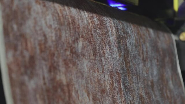 Modern wallpaper factory. Industrial printer making new wallpaper sample. Wallpaper production. One of step creation new wallpaper. Closeup