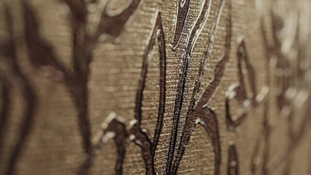 Rolls with wallpaper. Ornament close-up. Stand with wallpaper in the store