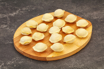 Raw dumplings over board for cooking