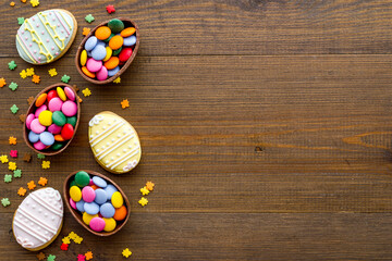 Happy Easter with chocolate eggs and sweets, top view