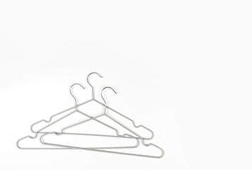Metal clothes hangers on a light background. Wardrobes were hung for clothes. Place for text