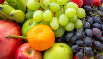 Naklejka na ściany i meble background: Mix of Assorted Fresh fruits at a shop for sale