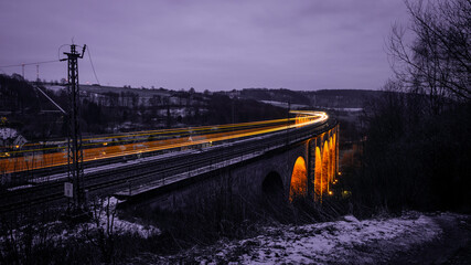Historic viaduct in Altenbeken in Ostwestfalen Germany with a moving train in winter