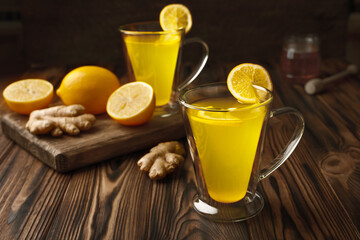 Two glass cup of lemon ginger lemonade and ingredients