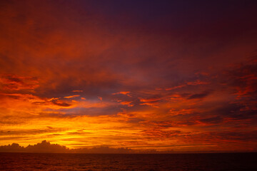 Orange sunset in Pacific Ocean after storm