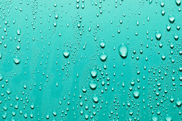 Fototapeta na wymiar Water drops on blue background, macro