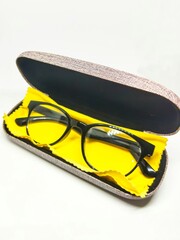 Black anti-radiation glasses are put in the box with a cloth to clean the glasses.