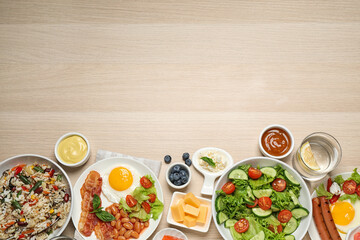 Different delicious dishes on buffet table, flat lay. Space for text