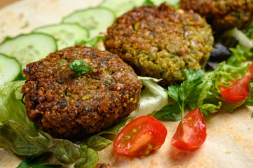 Homemade falafel on pita bread with tomatoes, cucumber and lettuce