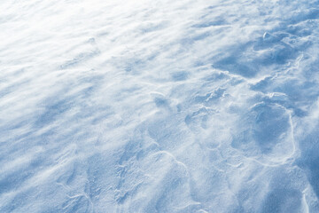 Blowing snow over snowy surface on top of mountain in Switzerland - snowstorm