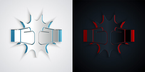 Paper cut Punch in boxing gloves icon isolated on grey and black background. Boxing gloves hitting together with explosive. Paper art style. Vector.