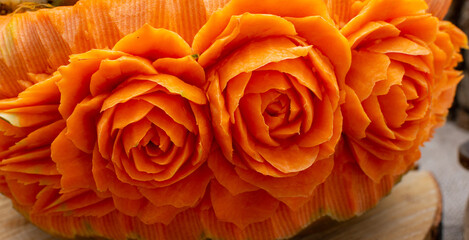 beautifully carved flowers on a pumpkin. art of carving