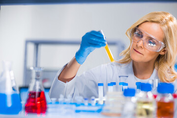 Professional female scientist is working on a vaccine in a modern scientific research laboratory. Genetic engineer workplace. Future technology and science.