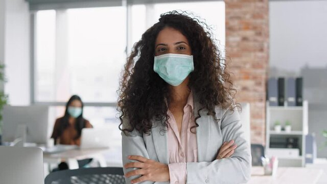 Video portrait of businesswoman in mask in the office. Shot with RED helium camera in 8K.
